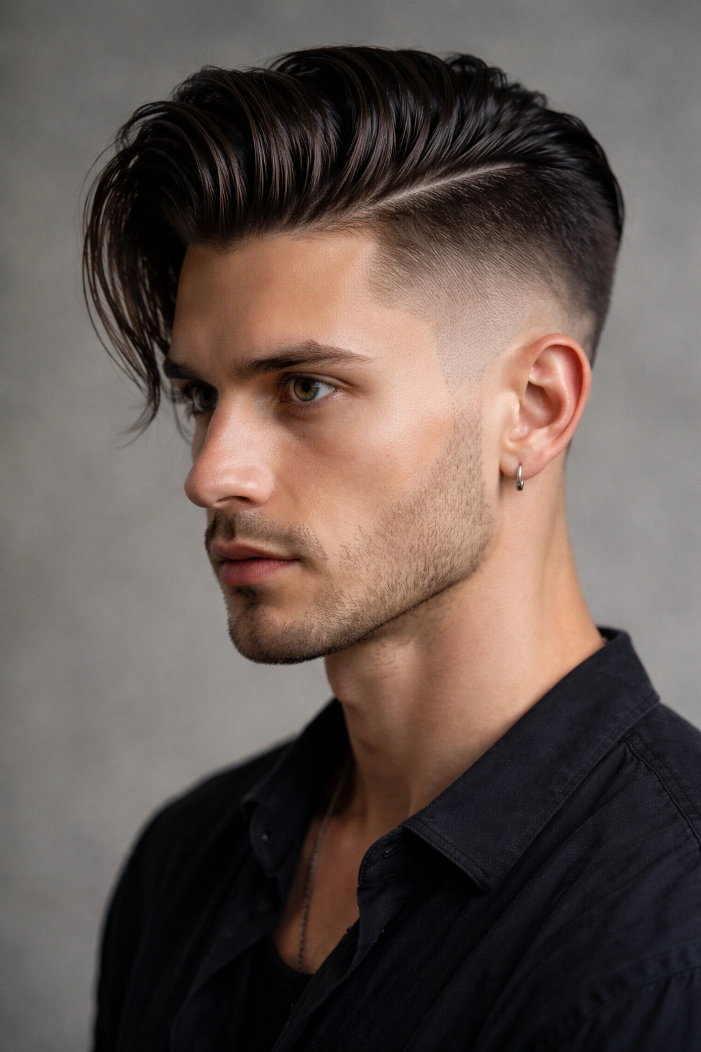 Close-up portrait of a hairstyle with a dramatic asymmetrical fade and slicked-back longer side
