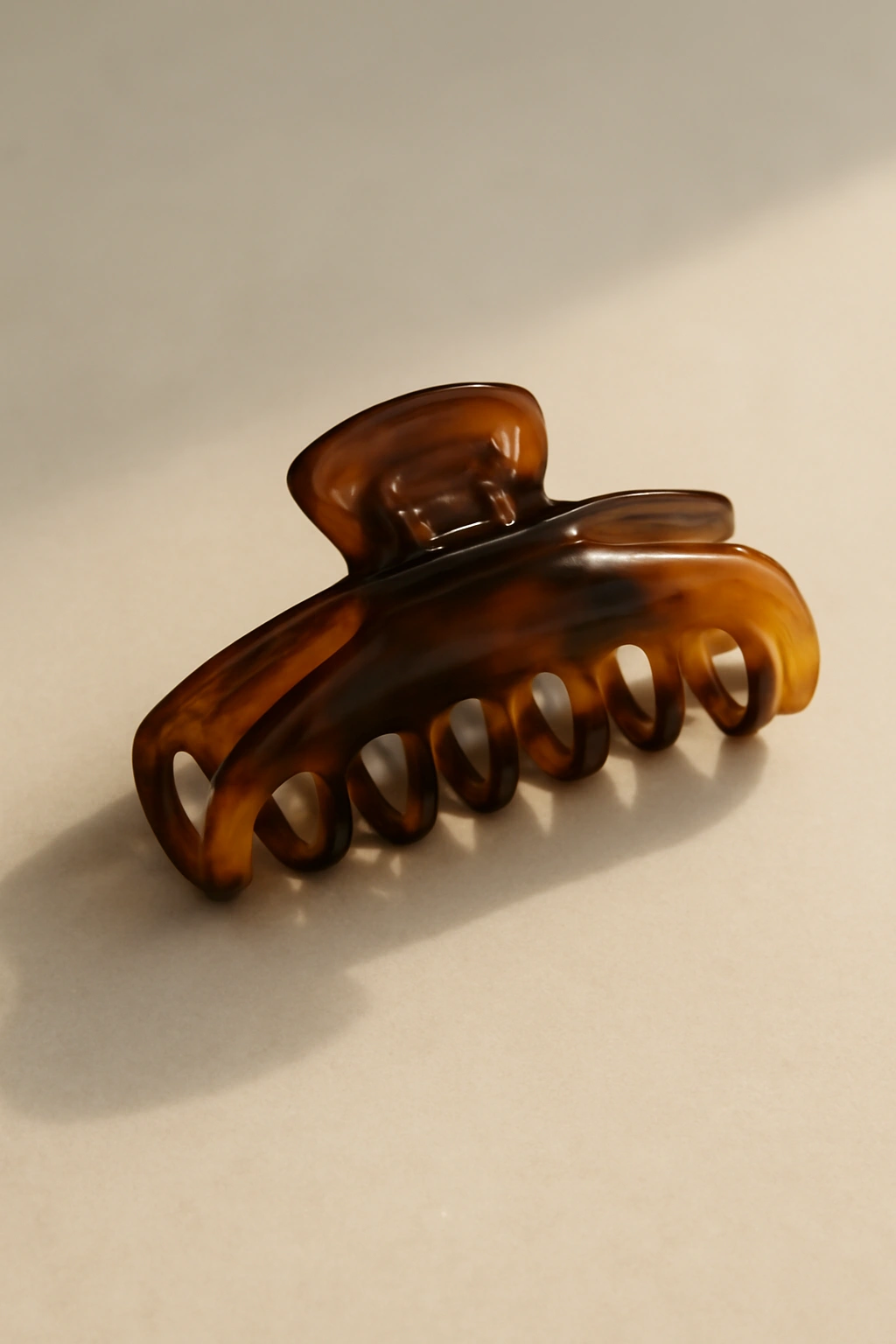Minimalist still life with a single claw clip on a clean surface