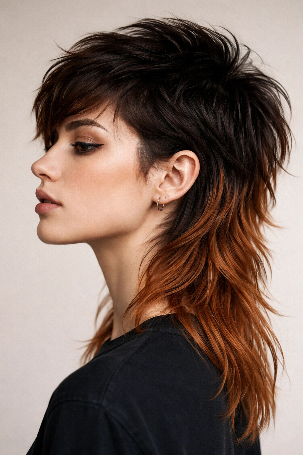 Close-up profile of a dyed mullet with darker roots and copper back