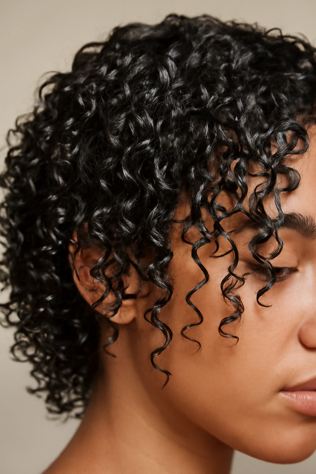 Close-up of damp gel-coated curls with defined and separated strands