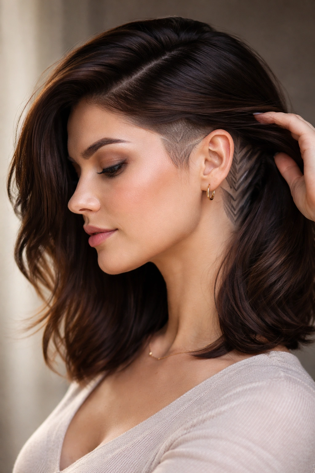 Hair with a concealed undercut visible at the nape when lifted, side-parted for volume