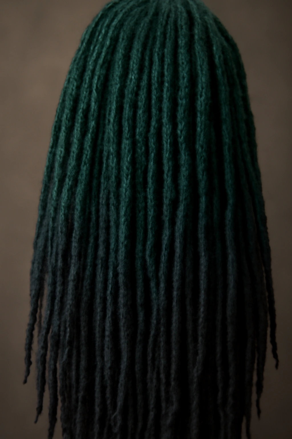 Close-up of ombre colored locs with a vivid gradient
