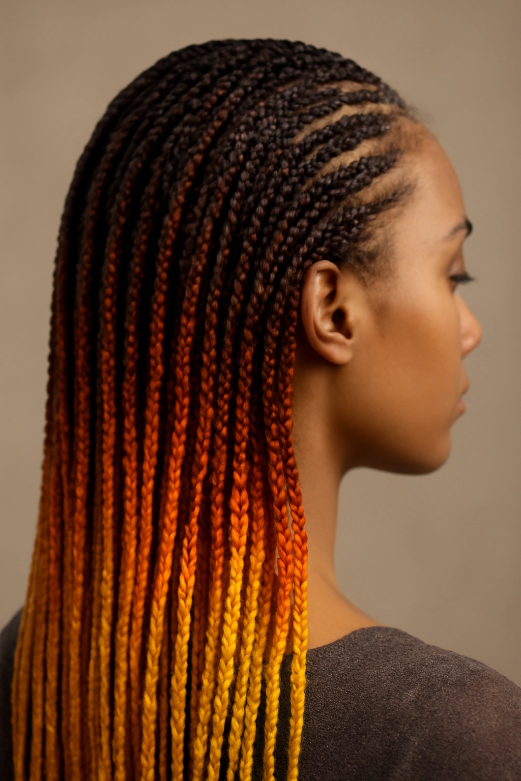 Micro braids in an ombre gradient from dark roots to light tips
