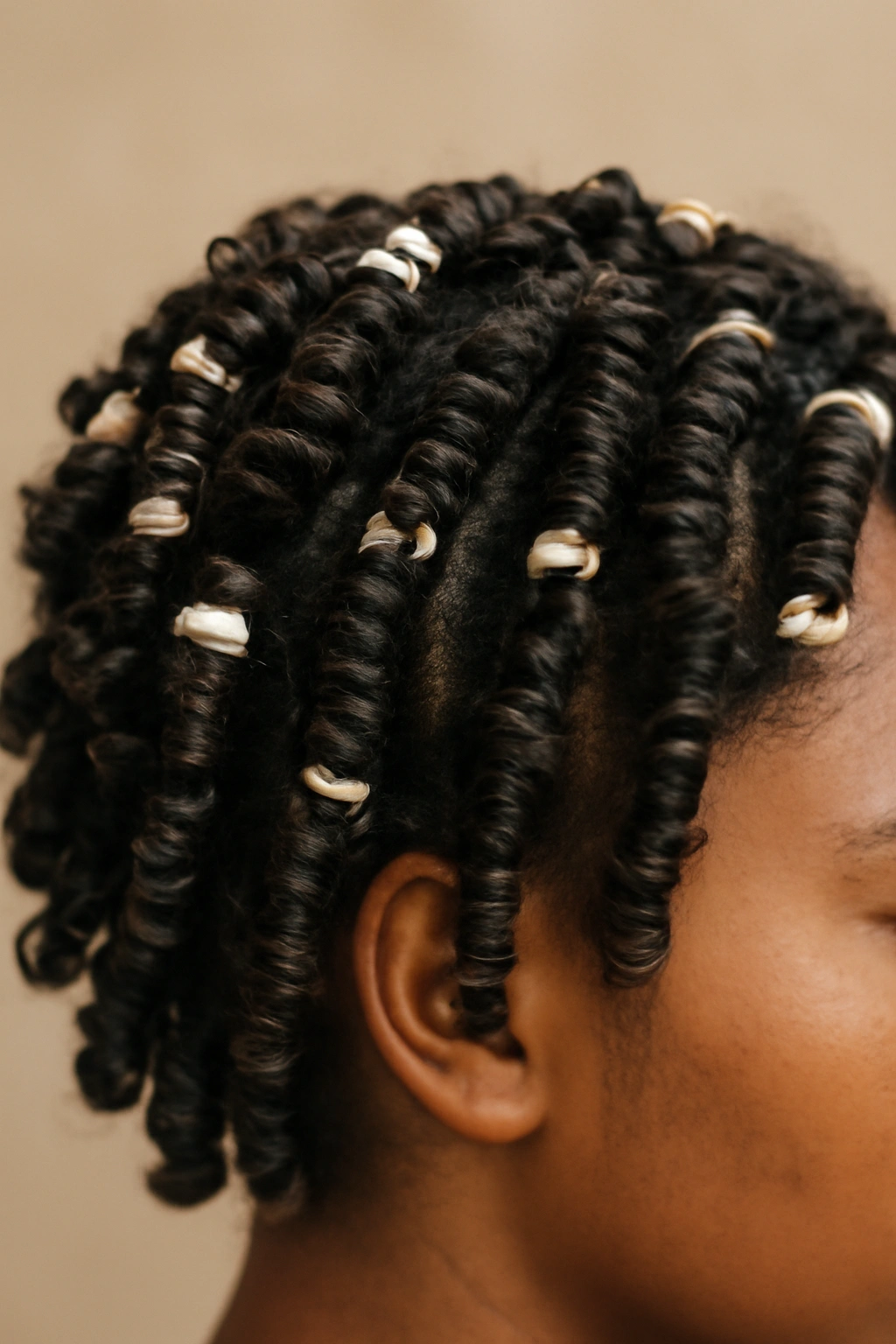 Close-up of short curls formed with perm rods to create defined spirals.