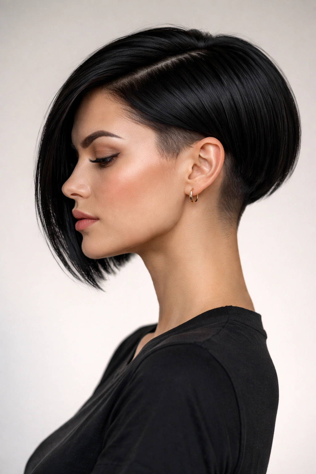 Head-and-shoulders portrait of a straight-haired sleek undercut bob with short sides