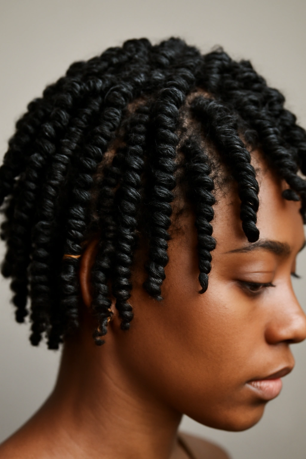 Close-up of defined spiral twist outs on short natural hair with corkscrew coils