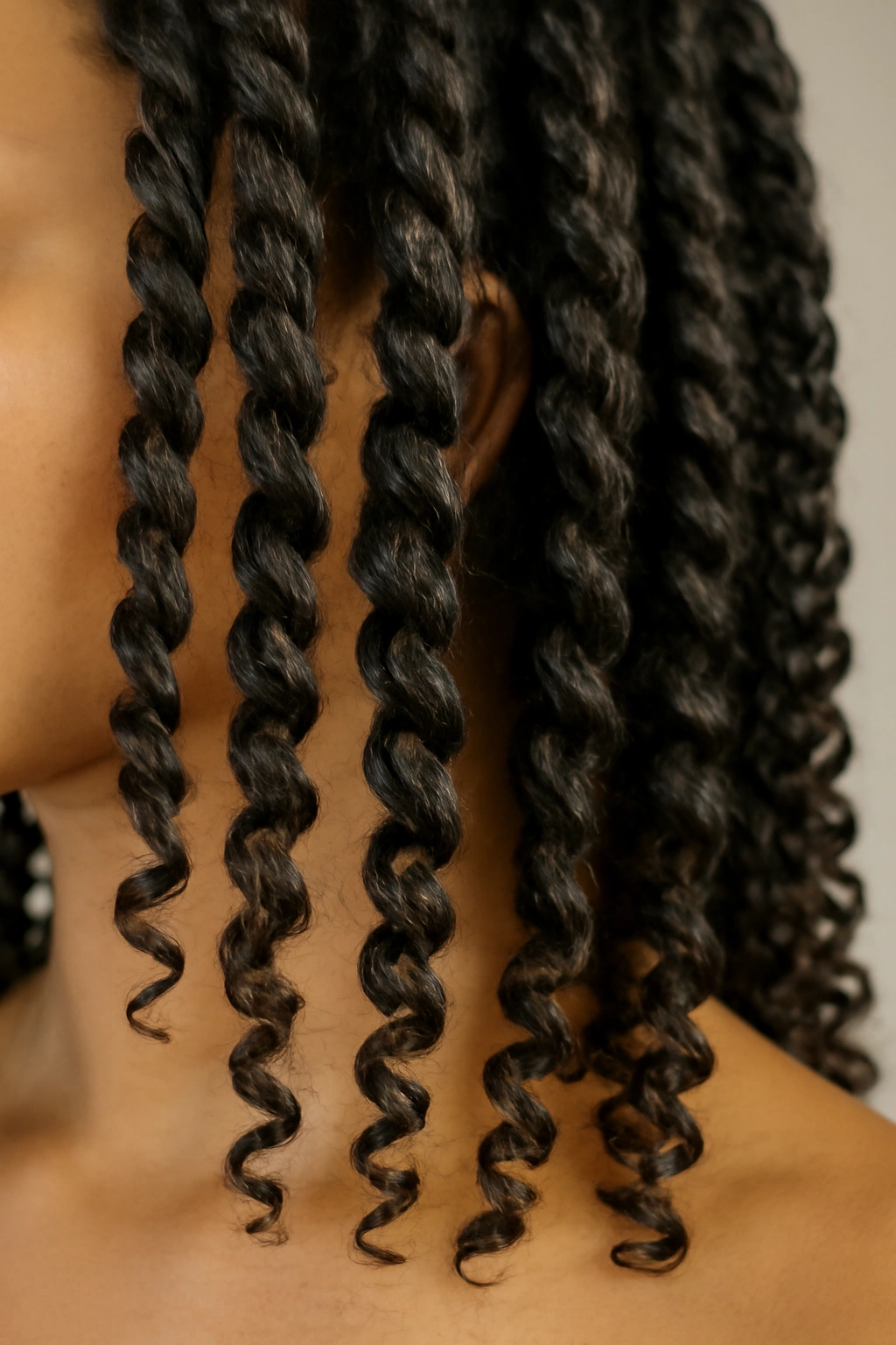 Close-up of hair in even two-strand twists forming defined curls