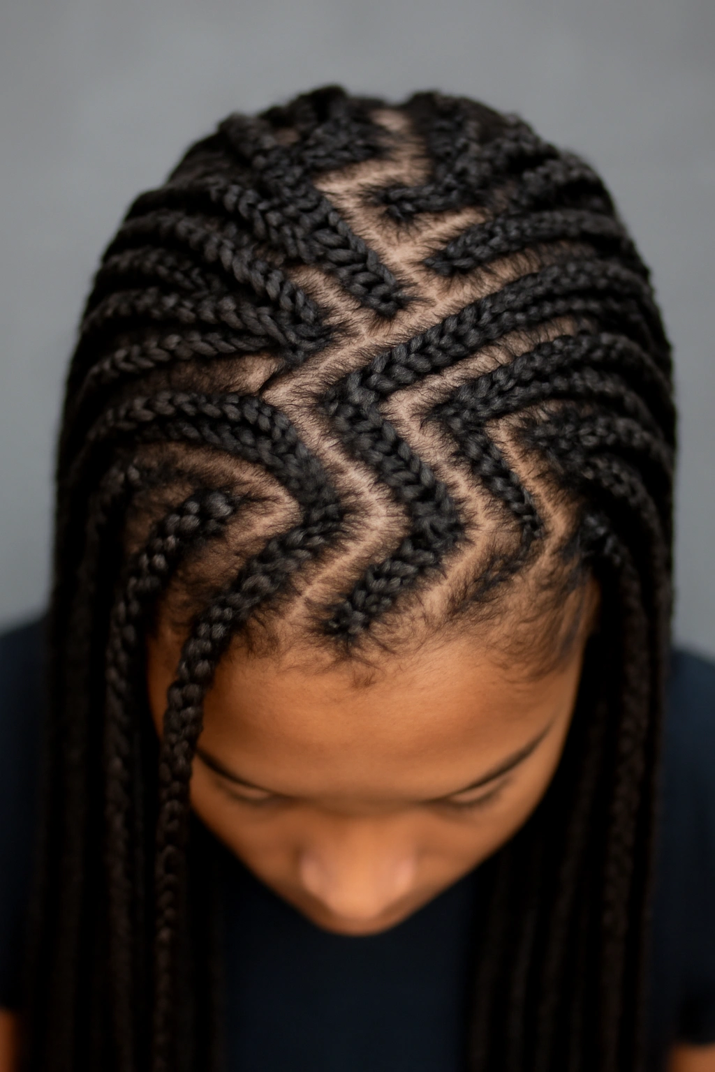 Top-down view of box braids with a zigzag parting pattern.